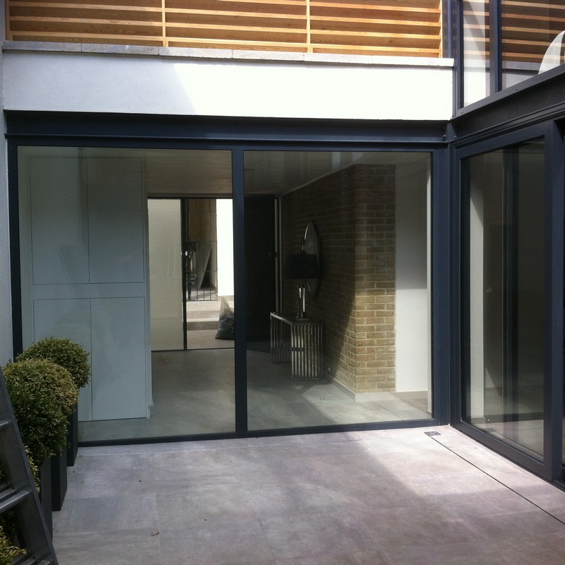 Floor-to-ceiling sliding doors opening to courtyard in Woolwich
