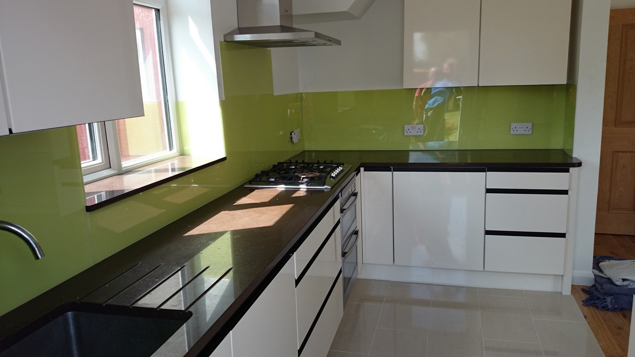 Lime green glass kitchen splashback installed by Woolwich glaziers