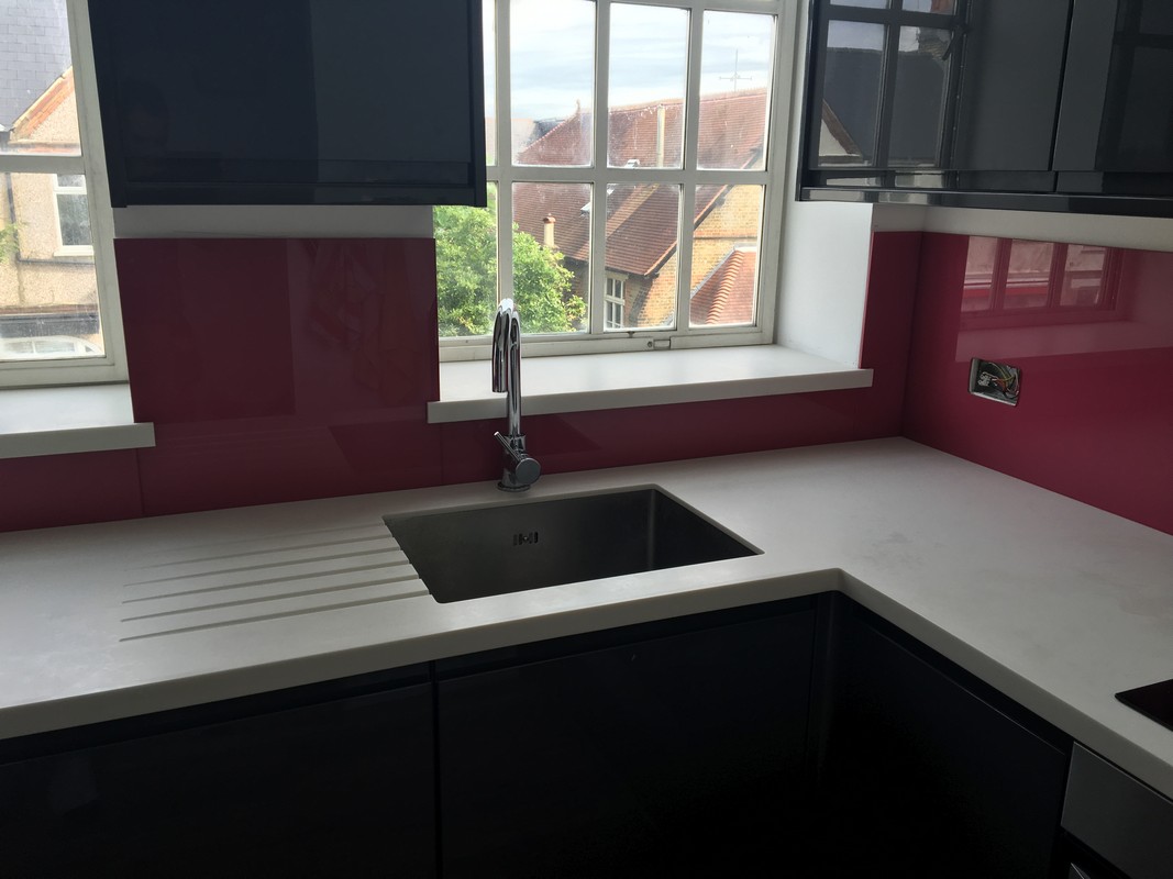 Deep plum coloured glass splashback in modern Woolwich kitchen